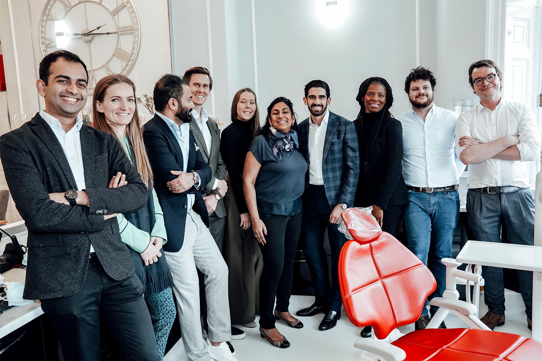 121 dental team standing together in dental surgery room