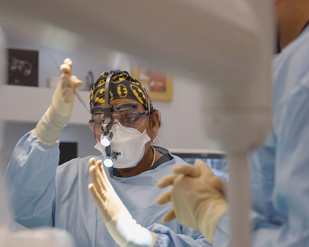 121 dental team standing together in dental surgery room